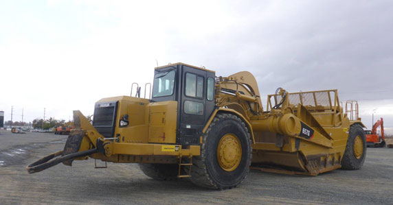 2009 Manitowoc crawler crane sold by Ritchie Bros. Cat motor scrapers sold by Ritchie Bros.